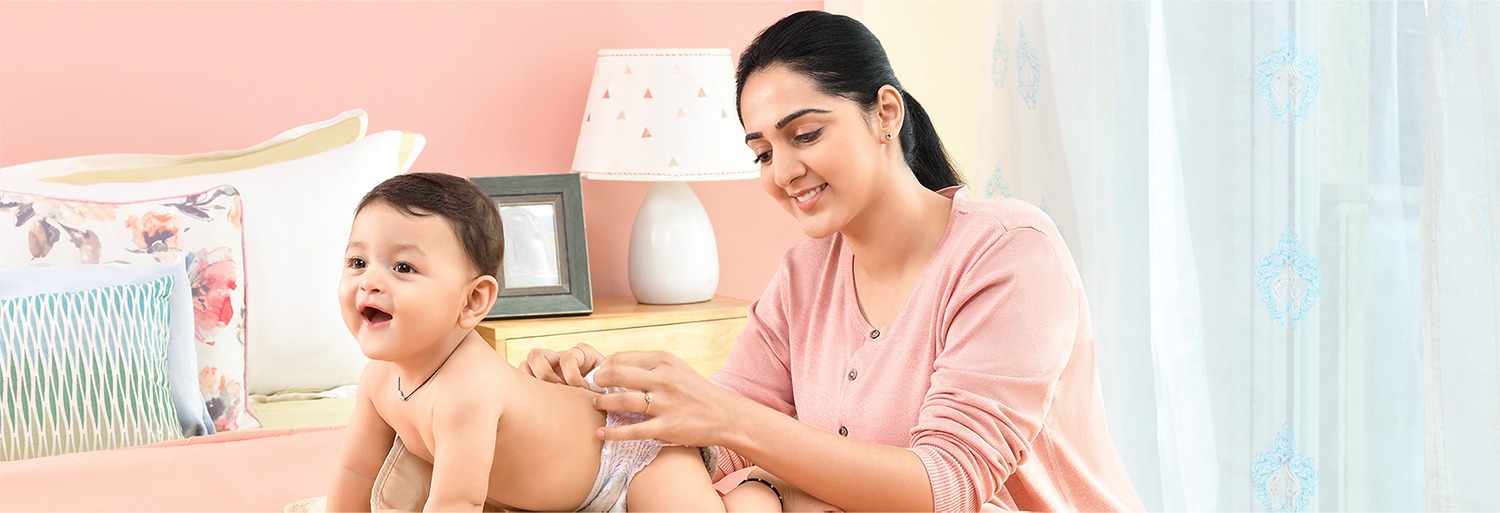 Mother changing her baby's diaper at home