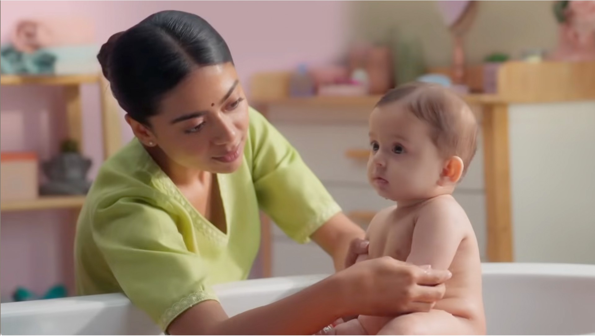 Mother bathing her baby