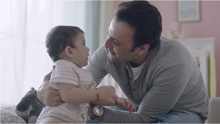 Father holding baby, health and hygiene campaign