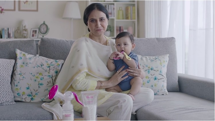 Mother with baby and breastfeeding accessories