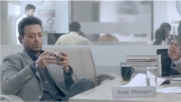 Campaign still, bank manager at his desk