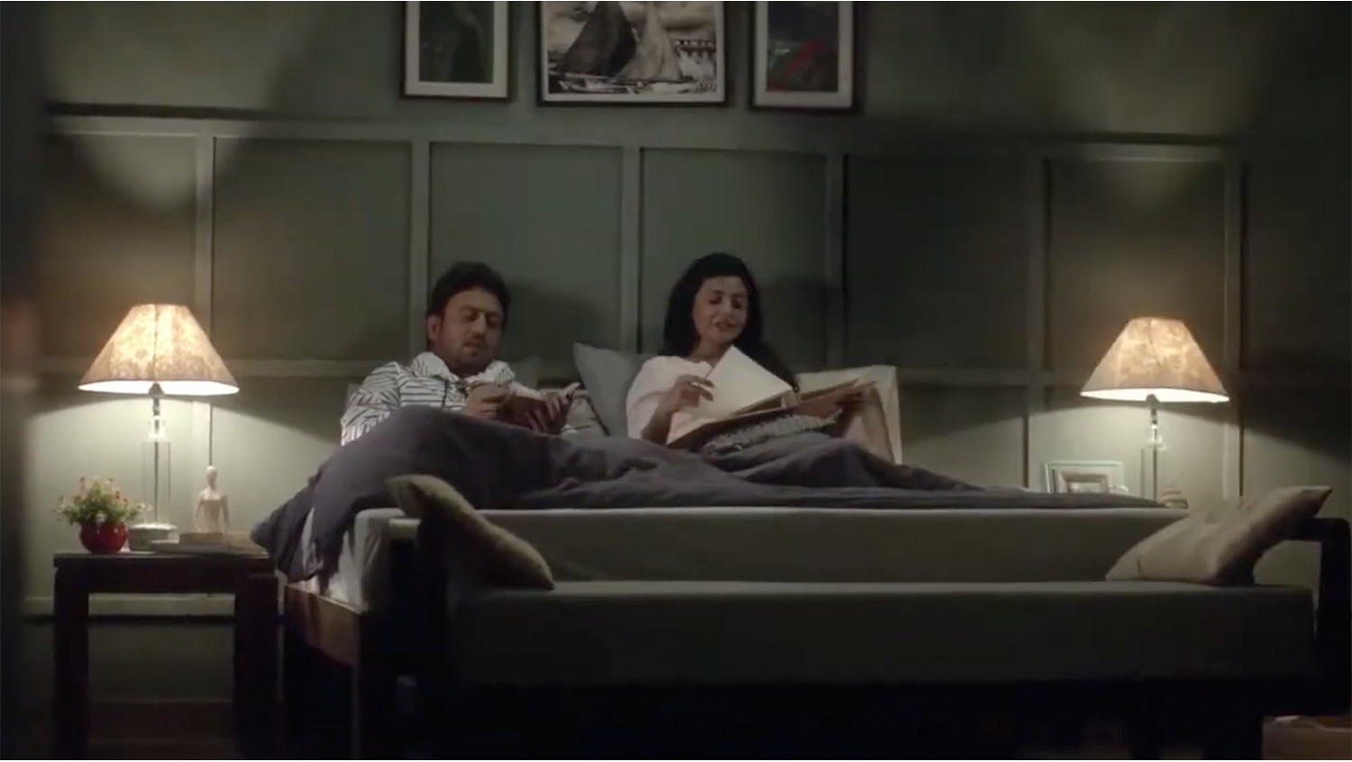 Couple reading in bed, campaign still